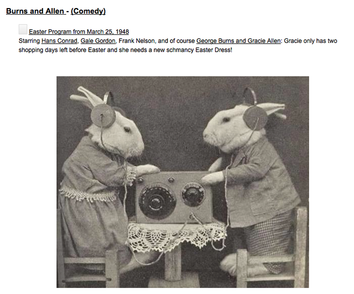 Believe it or not, this is a photo of two bunnies dressed in clothing, standing on miniature chairs at a table with radio equipment on it. Of course, they are wearing earphones.