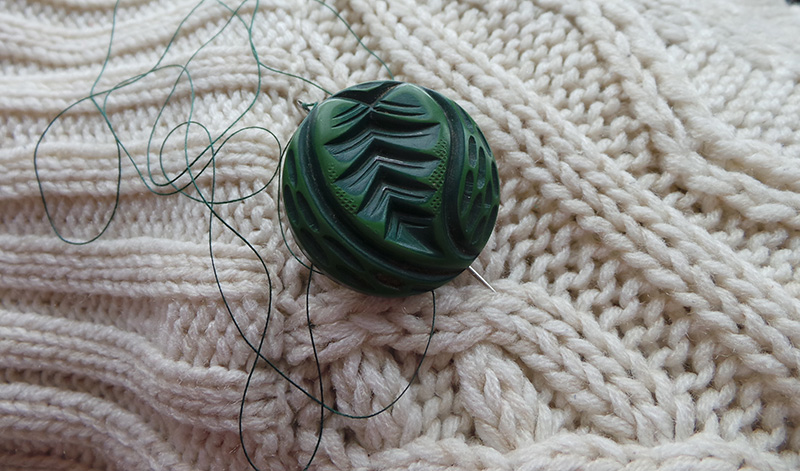 A green button from my mom's old car-coat.
