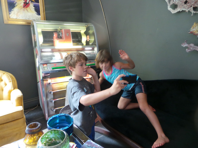 Some kids like taking a picture with the juke box more than others.