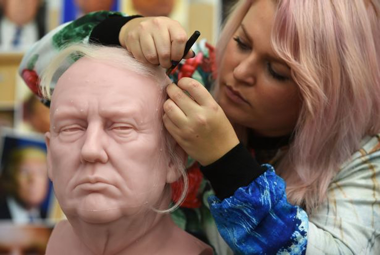 Madame Tussaud's Sophie Crudgington inserts Yak hairs onto the unfinished wax figure of Donald Trump.