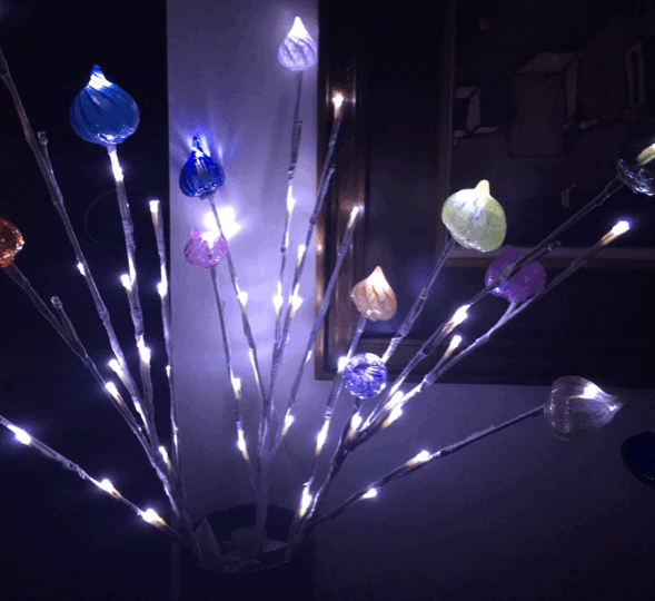 Little glass bits by David Duthie amid twinkling white lights.